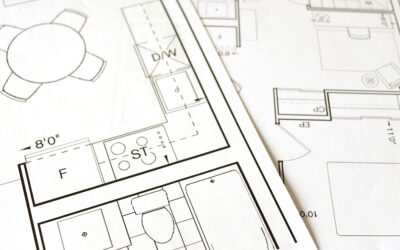 Close-up view of an architectural floor plan on paper showcasing detailed room layouts and measurements.